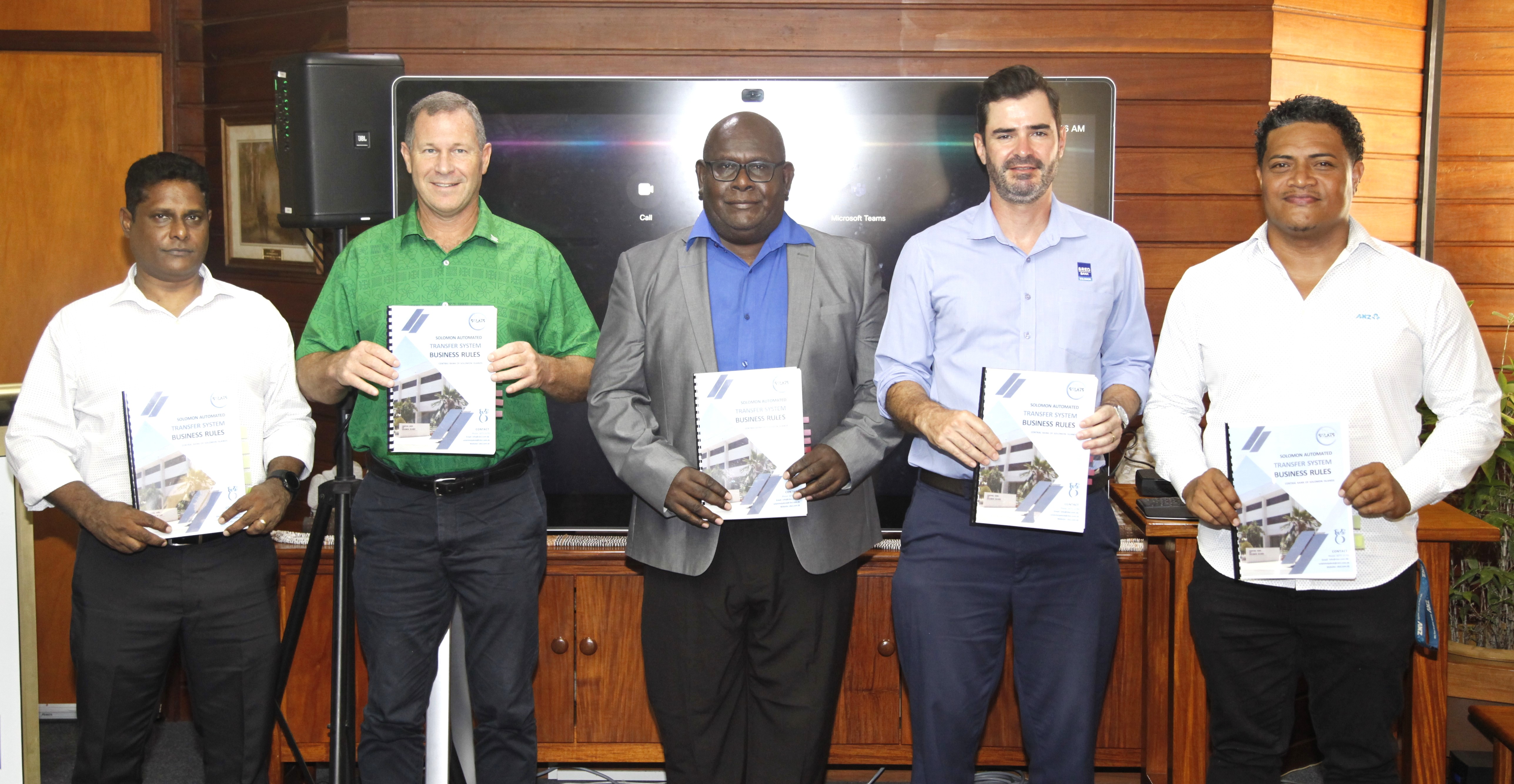 CBSI Deputy Governor Raynold Moveni standing third from right with commercial banks' heads. 